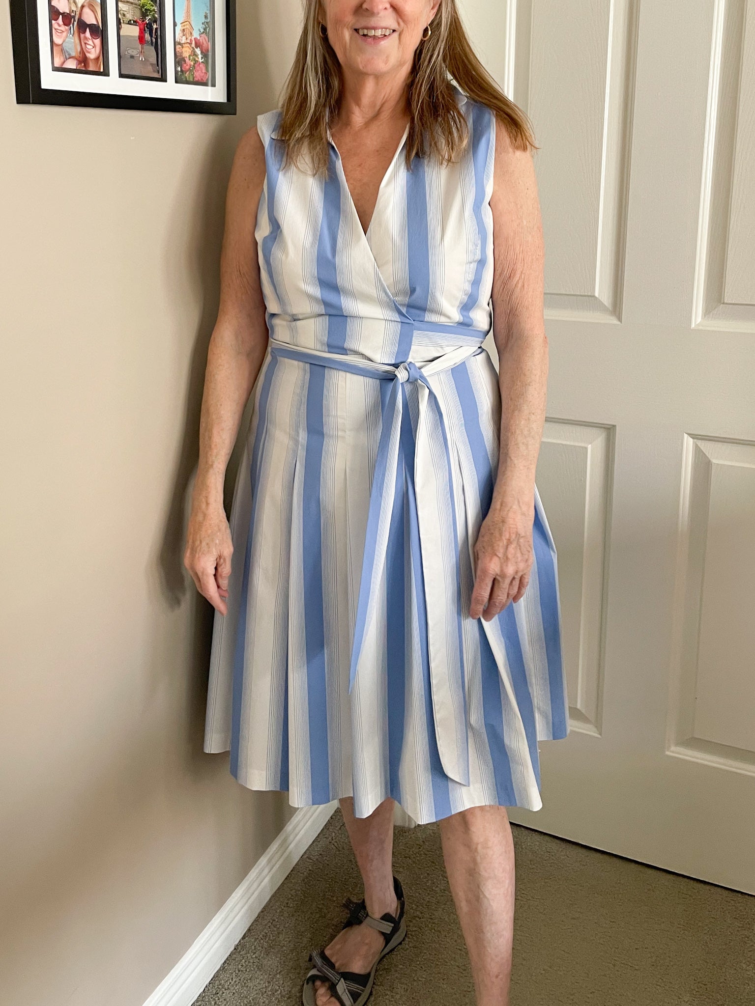 Woman modeling blue and white Ivanka Trump striped fit-and-flare dress, shown from multiple angles. Close-up of fabric tags showing cotton blend and dry clean instructions.