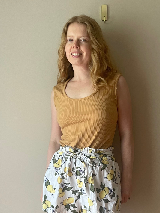 Woman wearing Buffalo David Bitton camel ribbed sleeveless tank paired with patterned skirts for a fresh summer outfit.